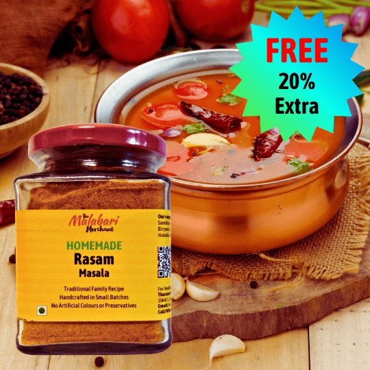 Jar of The Malabari Merchant Homemade Rasam Masala with a bowl of rasam on a wooden surface.